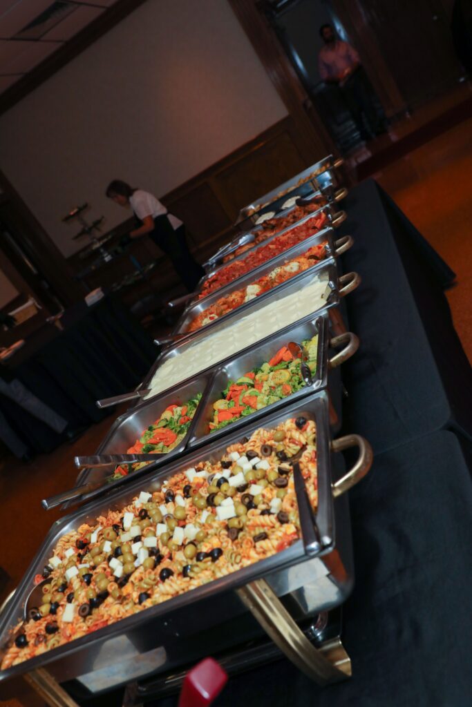 A buffet spread featuring various dishes, including pasta